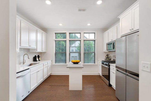 kitchen featuring white cabinetry, stainless steel appliances, dark wood-type flooring, and sink