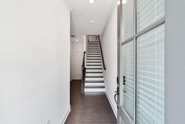 corridor with dark hardwood / wood-style flooring