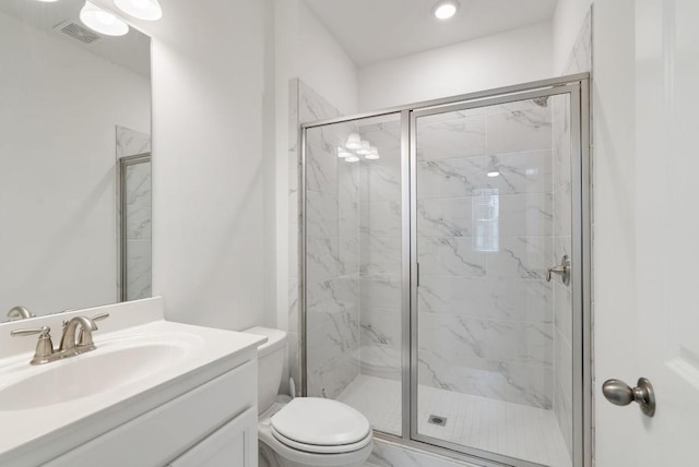 bathroom with an enclosed shower, vanity, and toilet