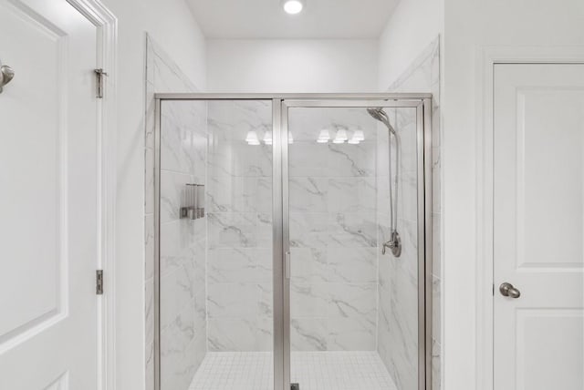 bathroom featuring a shower with shower door