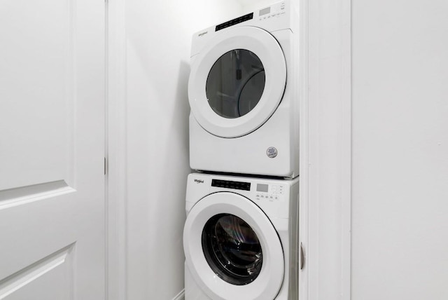 laundry area featuring stacked washer / drying machine