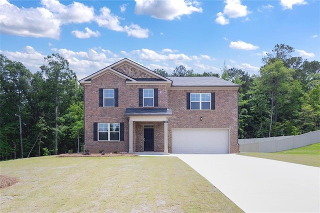 view of front of home with an attached garage, brick siding, fence, driveway, and a front lawn