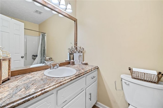 bathroom with visible vents, toilet, vanity, a textured ceiling, and a shower with curtain