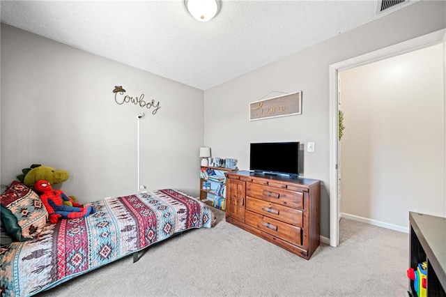 bedroom featuring a textured ceiling, carpet floors, visible vents, and baseboards