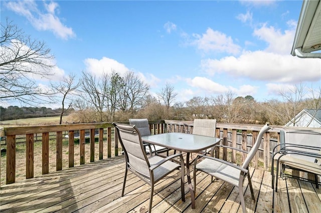 wooden terrace with outdoor dining area