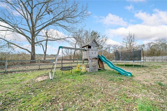 view of play area featuring a yard, a trampoline, and fence