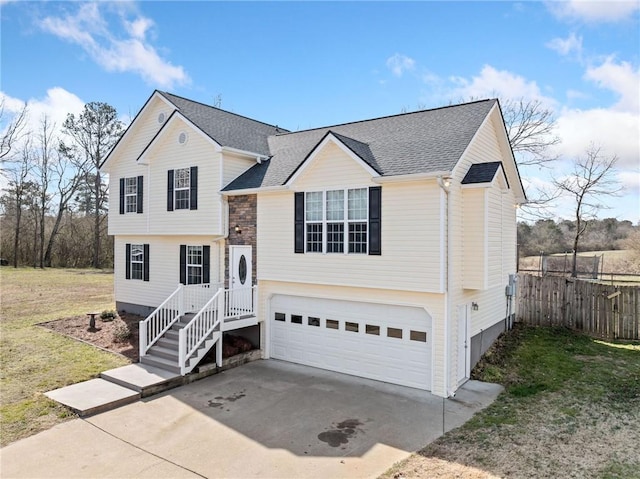 view of front facade featuring concrete driveway, roof with shingles, an attached garage, fence, and a front lawn