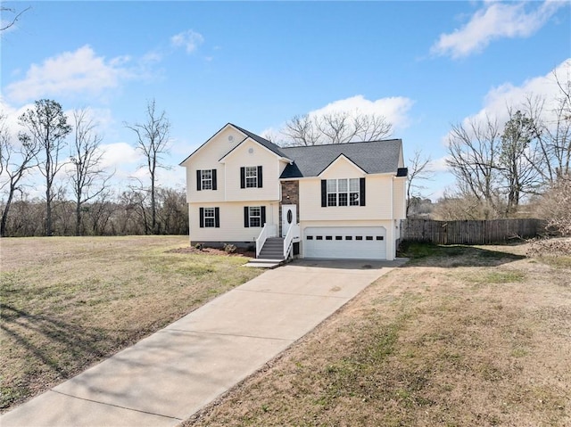 view of front of home featuring a garage, concrete driveway, a front lawn, and fence