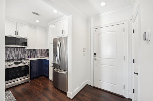 kitchen featuring white cabinetry, stainless steel appliances, dark wood-style floors, and light countertops