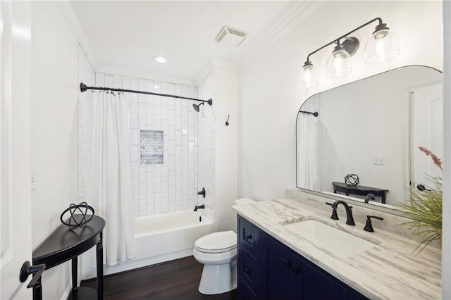 full bath with toilet, visible vents, wood finished floors, vanity, and ornamental molding