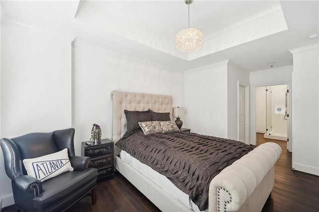 bedroom featuring wood finished floors, a chandelier, a raised ceiling, baseboards, and ornamental molding