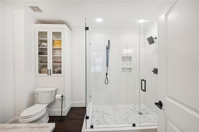 full bath featuring wood finished floors, visible vents, toilet, baseboards, and a stall shower