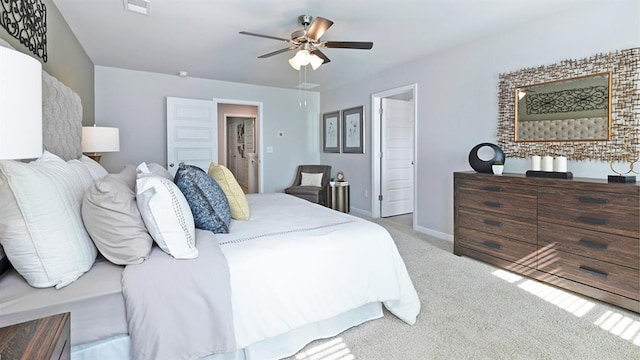 carpeted bedroom featuring ceiling fan, visible vents, and baseboards