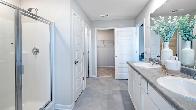 full bathroom featuring a sink, visible vents, and a shower stall