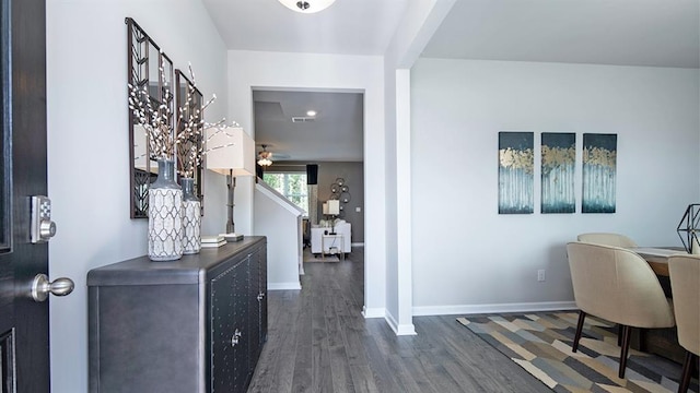 entryway with dark wood-type flooring, visible vents, and baseboards