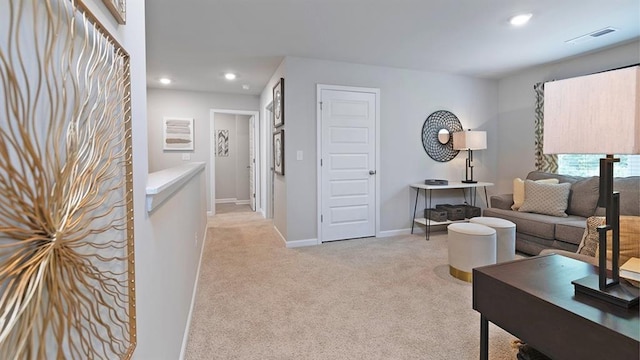 living room with recessed lighting, light colored carpet, visible vents, and baseboards