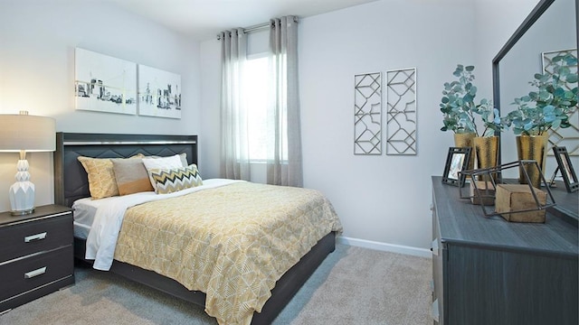 carpeted bedroom featuring baseboards