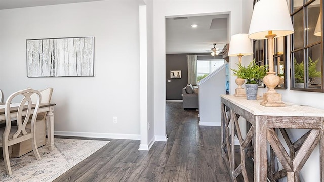 dining area featuring ceiling fan, visible vents, baseboards, and dark wood-type flooring