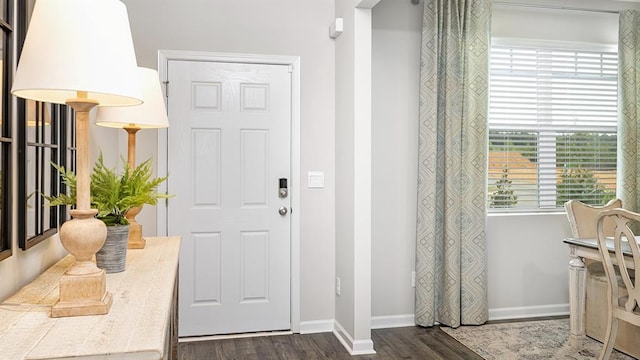 entryway featuring dark wood-style floors and baseboards