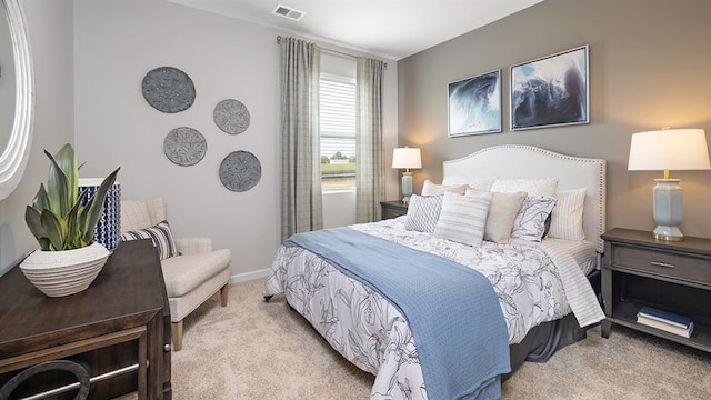 carpeted bedroom with visible vents and baseboards