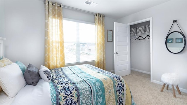 carpeted bedroom with baseboards, visible vents, and a closet