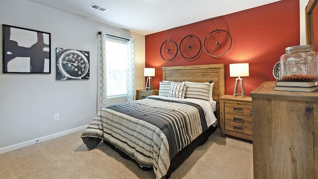 bedroom featuring light colored carpet, visible vents, and baseboards