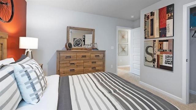 carpeted bedroom featuring baseboards