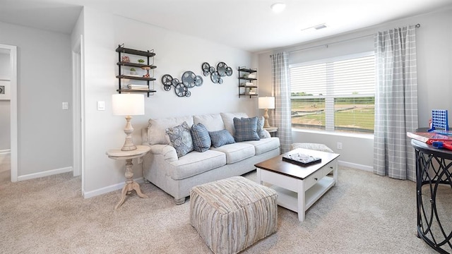 carpeted living area with visible vents and baseboards