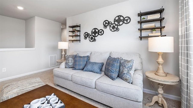 carpeted living area featuring visible vents and baseboards