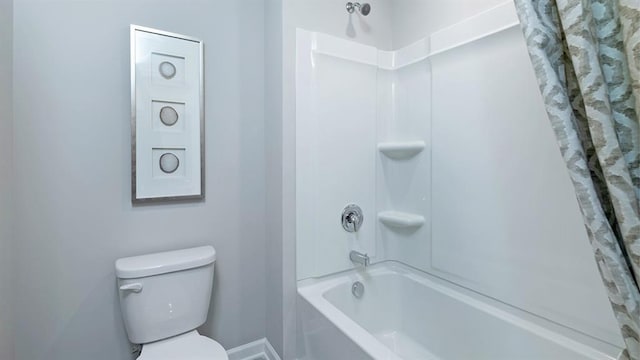 bathroom with shower / bath combination with curtain and toilet