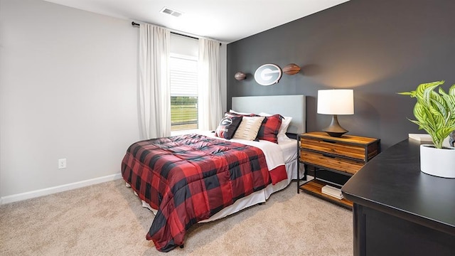 bedroom featuring carpet flooring, visible vents, and baseboards