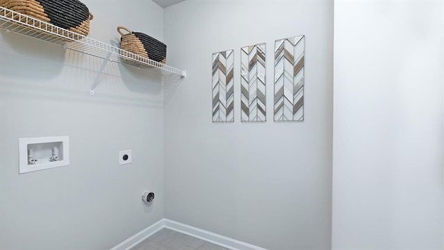 clothes washing area with laundry area, washer hookup, electric dryer hookup, and baseboards