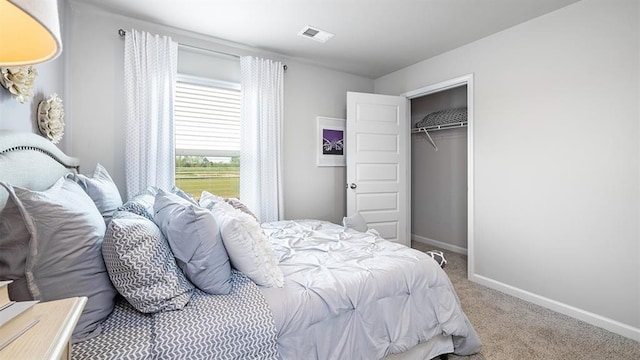 bedroom with baseboards, a closet, visible vents, and carpet flooring