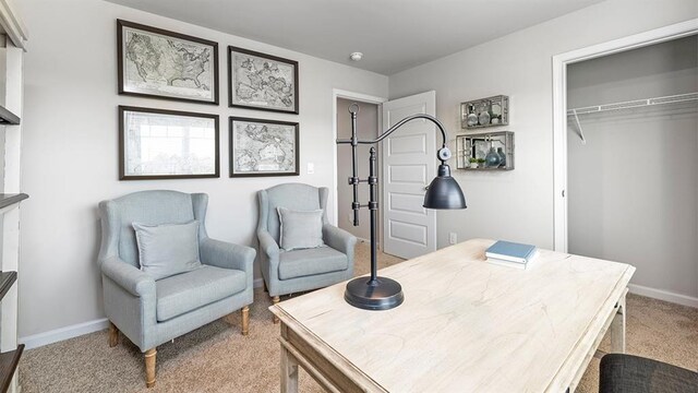 office space featuring light colored carpet and baseboards