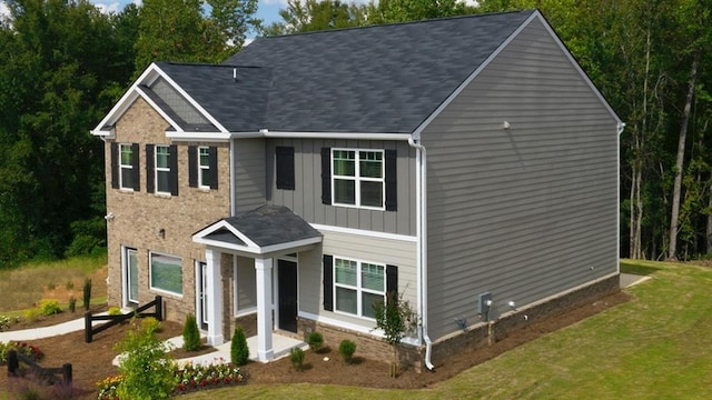 view of front facade featuring a front lawn and board and batten siding