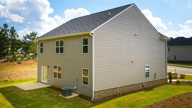 view of side of home featuring a yard and central air condition unit