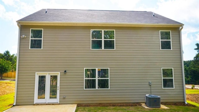 rear view of house featuring a patio area, central AC, and a yard