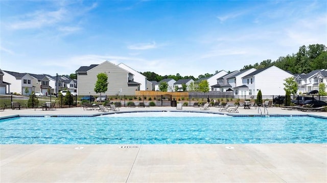 pool featuring a residential view, fence, and a patio