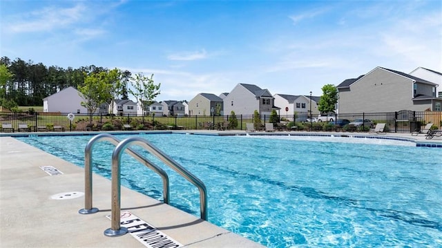 community pool with a residential view and fence