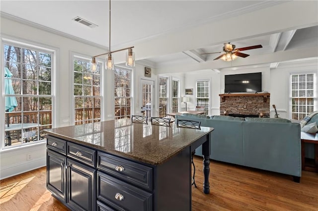 7105 Haw Crk, Gainesville, GA 30506 - kitchen featuring beamed ceiling, wood finished floors, a ceiling fan, and ornamental molding