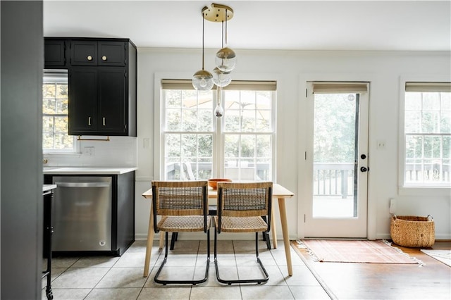 tiled dining room featuring ornamental molding