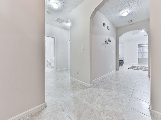 corridor featuring a textured ceiling