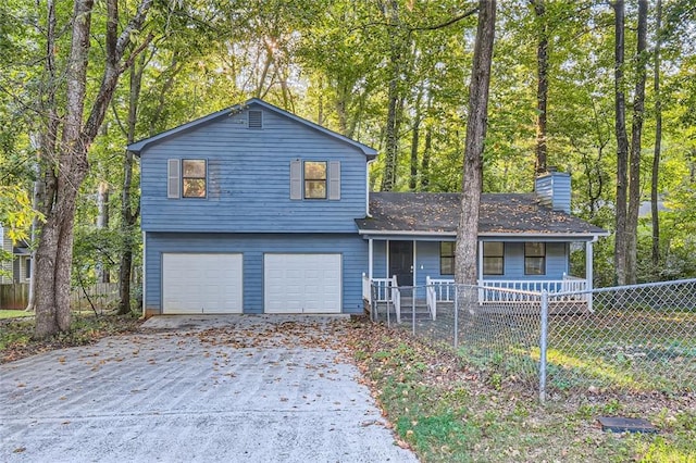 tri-level home featuring a garage and covered porch