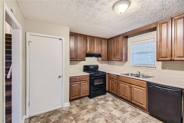 kitchen featuring black appliances, a textured ceiling, and sink