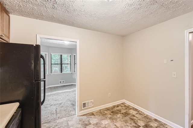 interior space with a textured ceiling