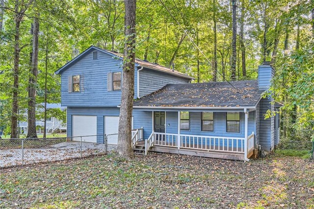 view of front of property with a garage and covered porch