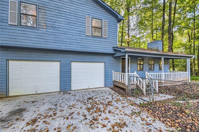 view of front of home with a garage and a porch