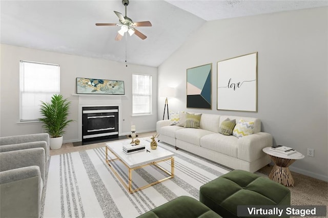 living room with ceiling fan, carpet flooring, and vaulted ceiling