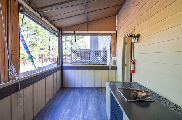 unfurnished sunroom featuring vaulted ceiling and a healthy amount of sunlight