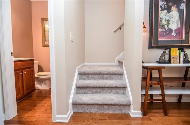 stairs featuring wood-type flooring